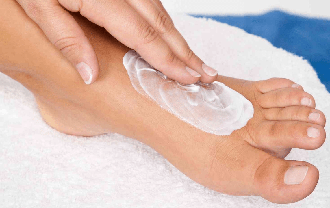 Applying an ointment for fungus on the feet